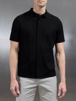 Mercerised Interlock Short Sleeve Button Through Shirt In Black 12 Mercerised Interlock Short Sleeve Button Through Shirt In Black -Cheap Shirts Shop MERCERISED INTERLOCK BUTTON THROUGH SHIRT IN BLACK 4635